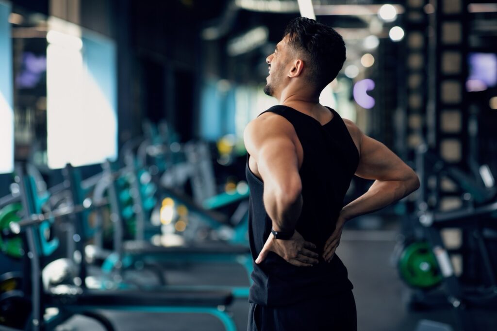 Portrait,Of,Young,Arab,Bodybuilder,Suffering,Lower,Back,Pain,At