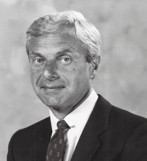 Black and white headshot of Dr. Fox, SCOI’s Founder, wearing a tie and jacket.